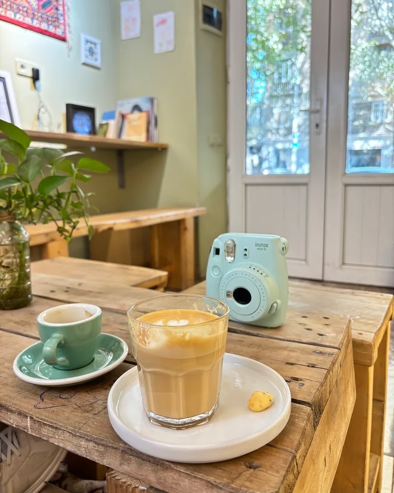 Cortado in a faceted glass with espresso cup at Station Cafe