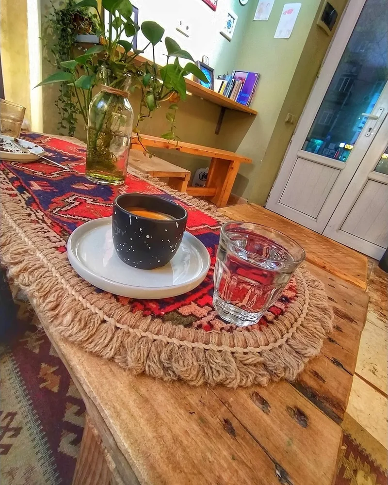 Espresso in a speckled black cup with water glass at Station Cafe