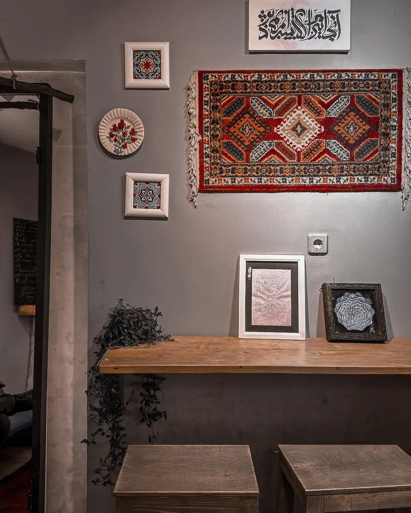 Seating counter with wooden stools and wall decor at Station Cafe