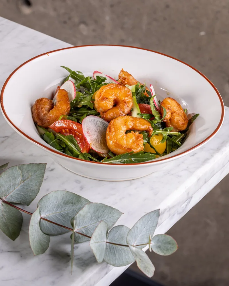 Shrimp salad in a white bowl with reddish rim at Steakhouse by Gastronome