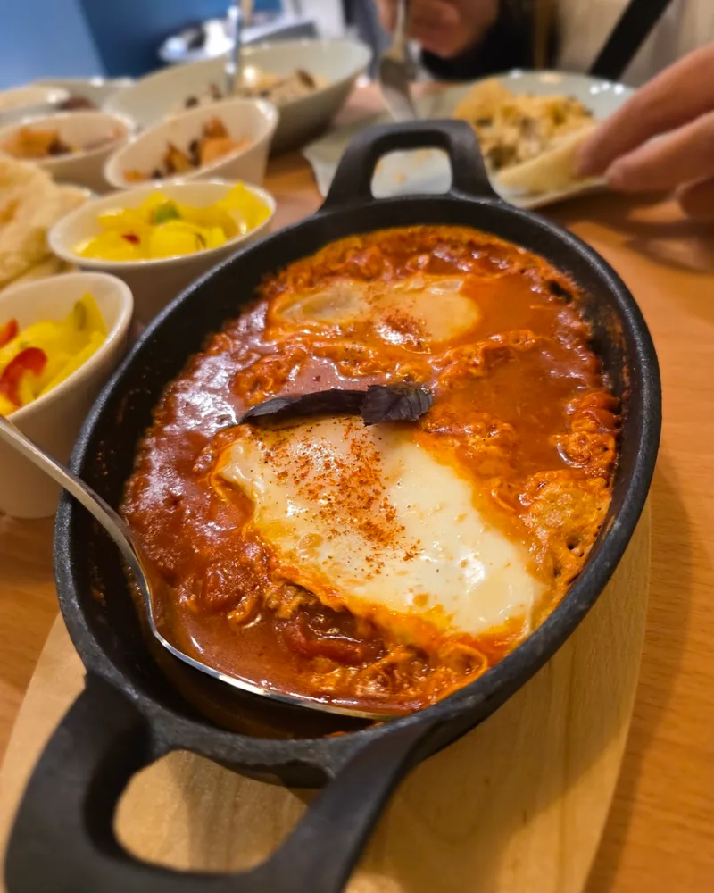 Shakshuka in a cast iron skillet at Supra Hummus