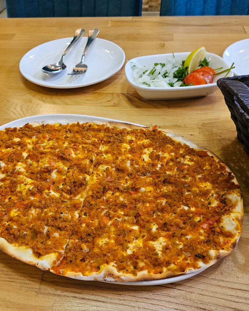 Lahmacun on an oval plate at Supra Turkish