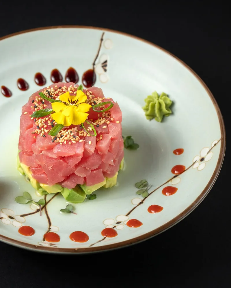 Tuna tartare with avocado and a yellow edible flower at Sushi Room