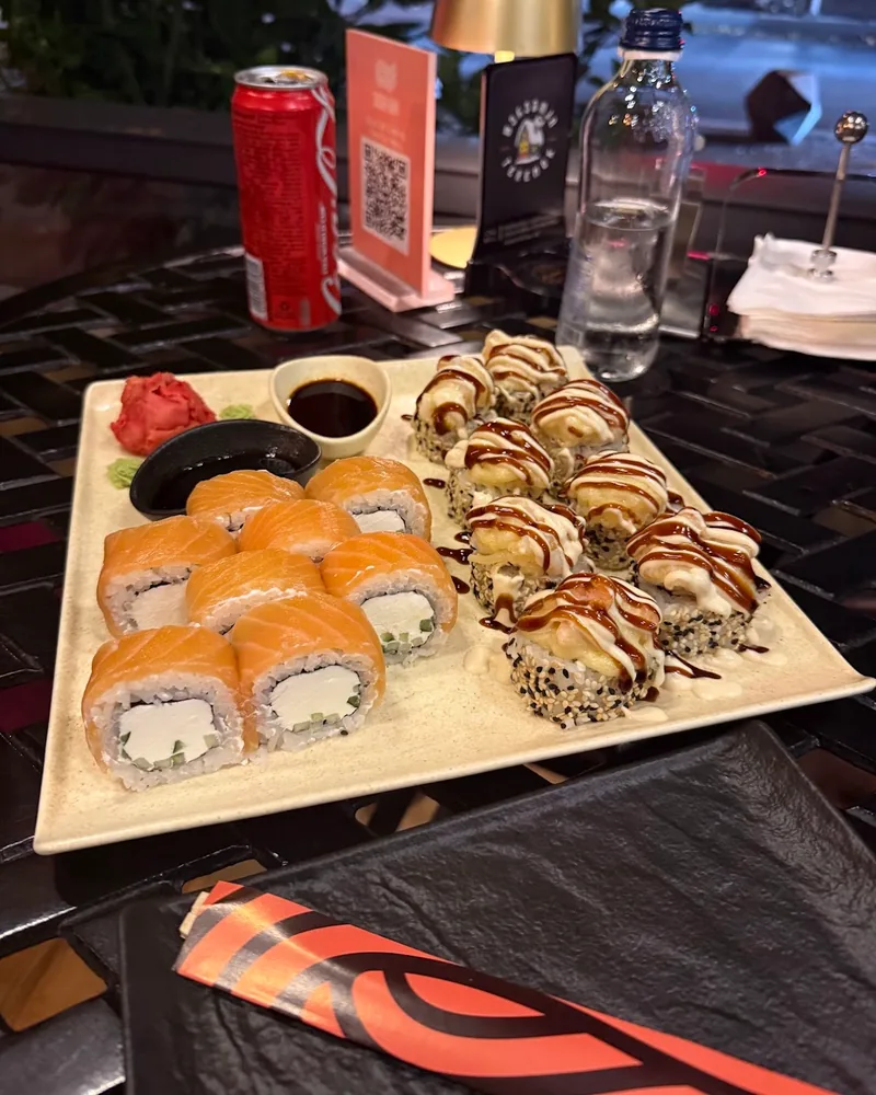 Sushi platter with salmon rolls and baked rolls at Sushi Way