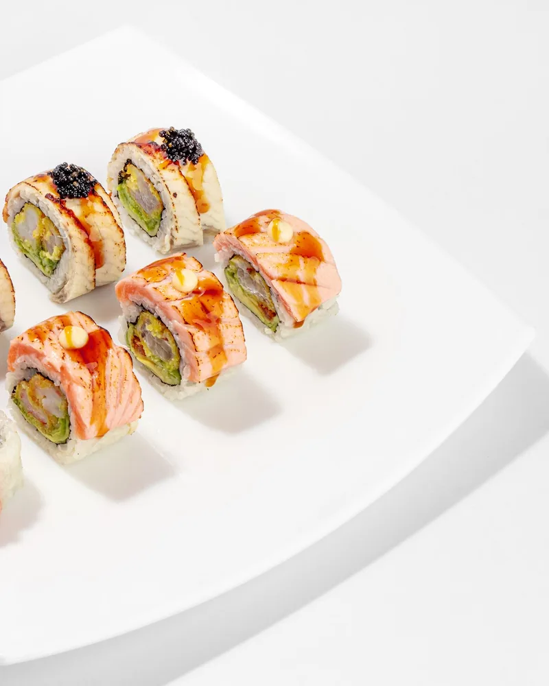 Assorted sushi rolls on a square white plate at Sushiman