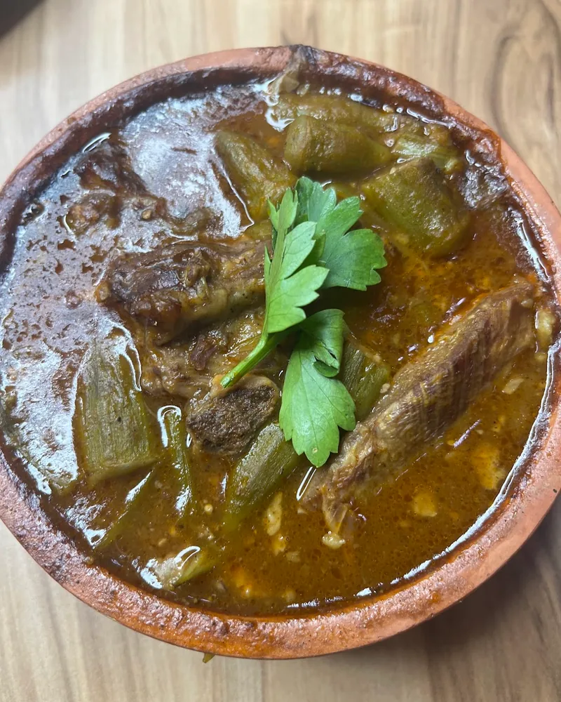 Okra and meat stew in an earthenware bowl at Tasty Town