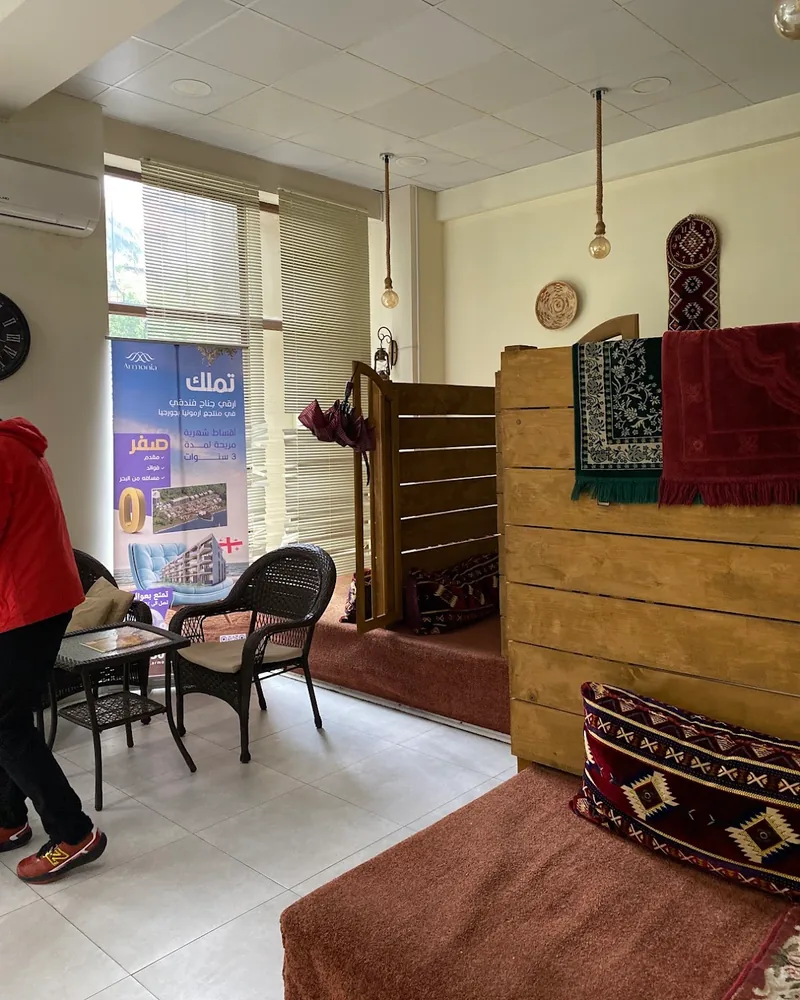 Arabic style seating area with wooden dividers and rugs at Tasty Town