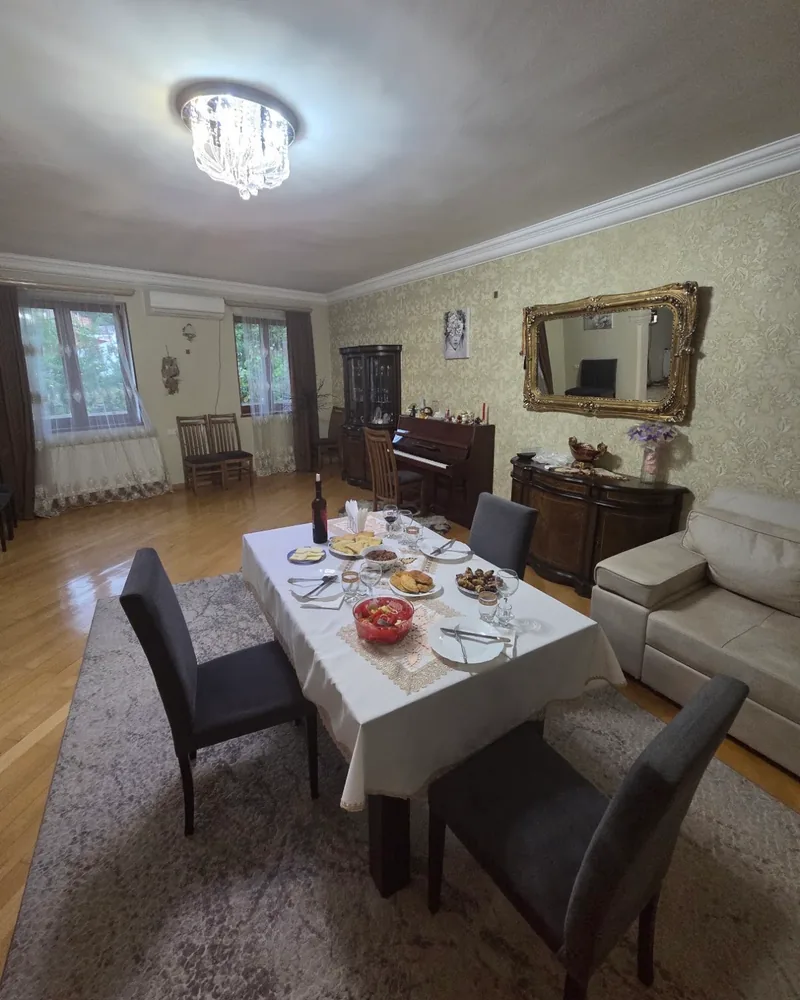 Dining room with set table and piano at Tbilisi Cooking Class