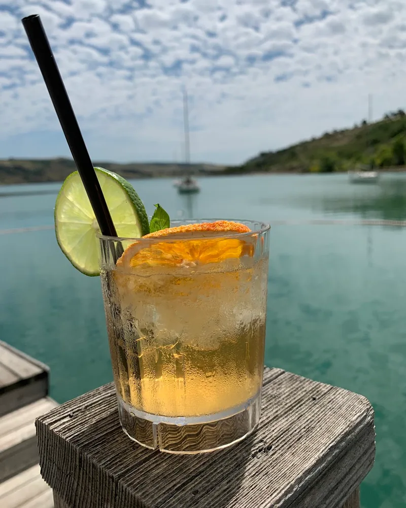 Cocktail in a rocks glass with dehydrated citrus and lime slice at La Cote