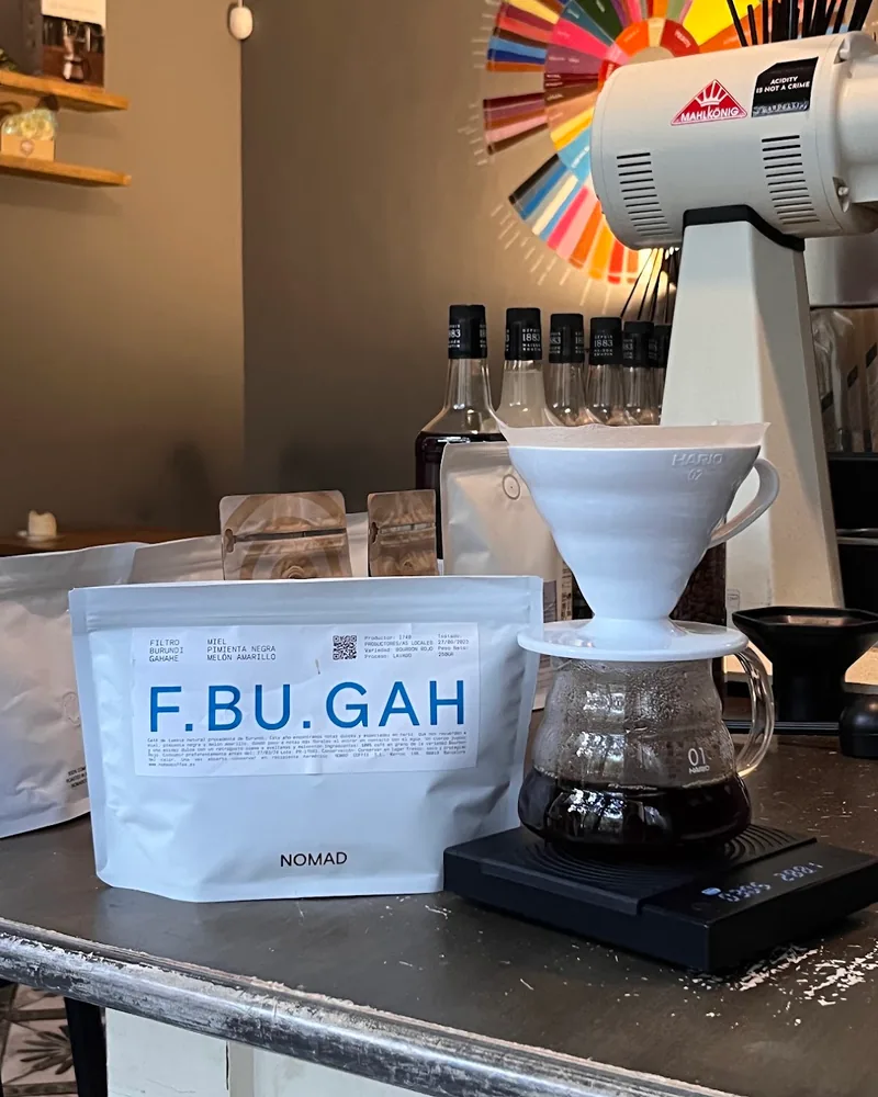 Pour-over coffee setup with dripper, server, and coffee bean bag at The Little