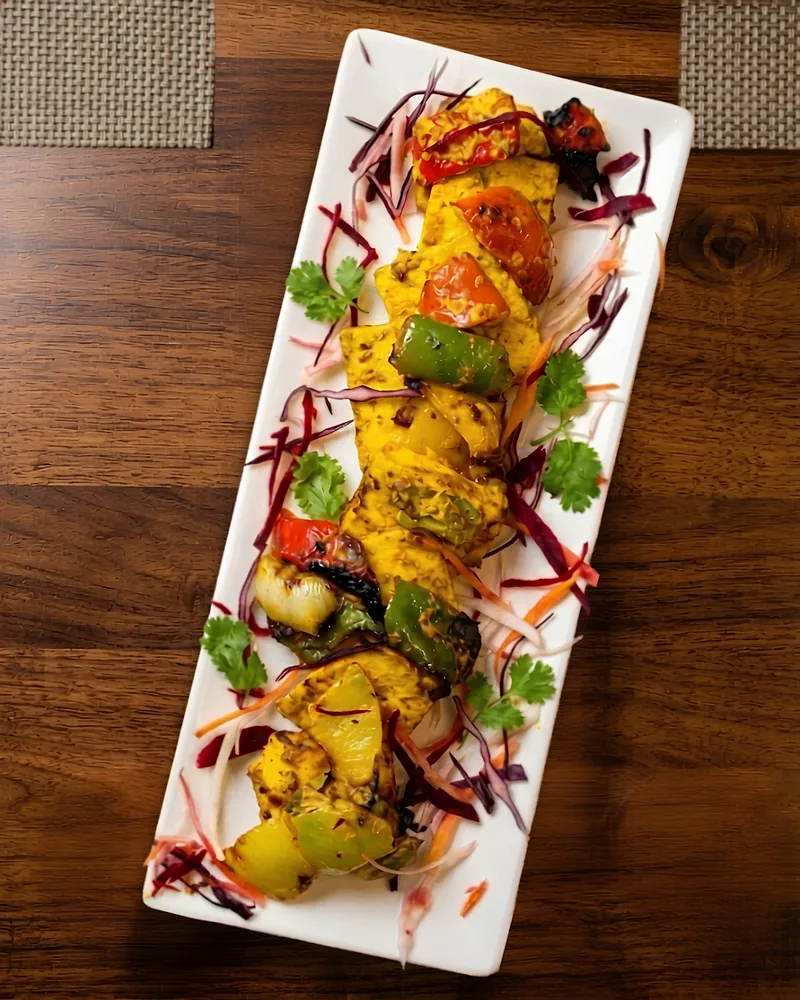Paneer tikka on a rectangular white platter at The Master Chef