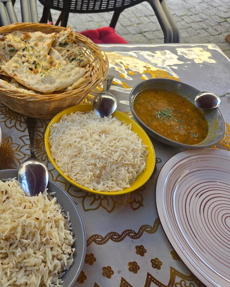 Indian meal spread with curry, rice and naan at The Master Chef