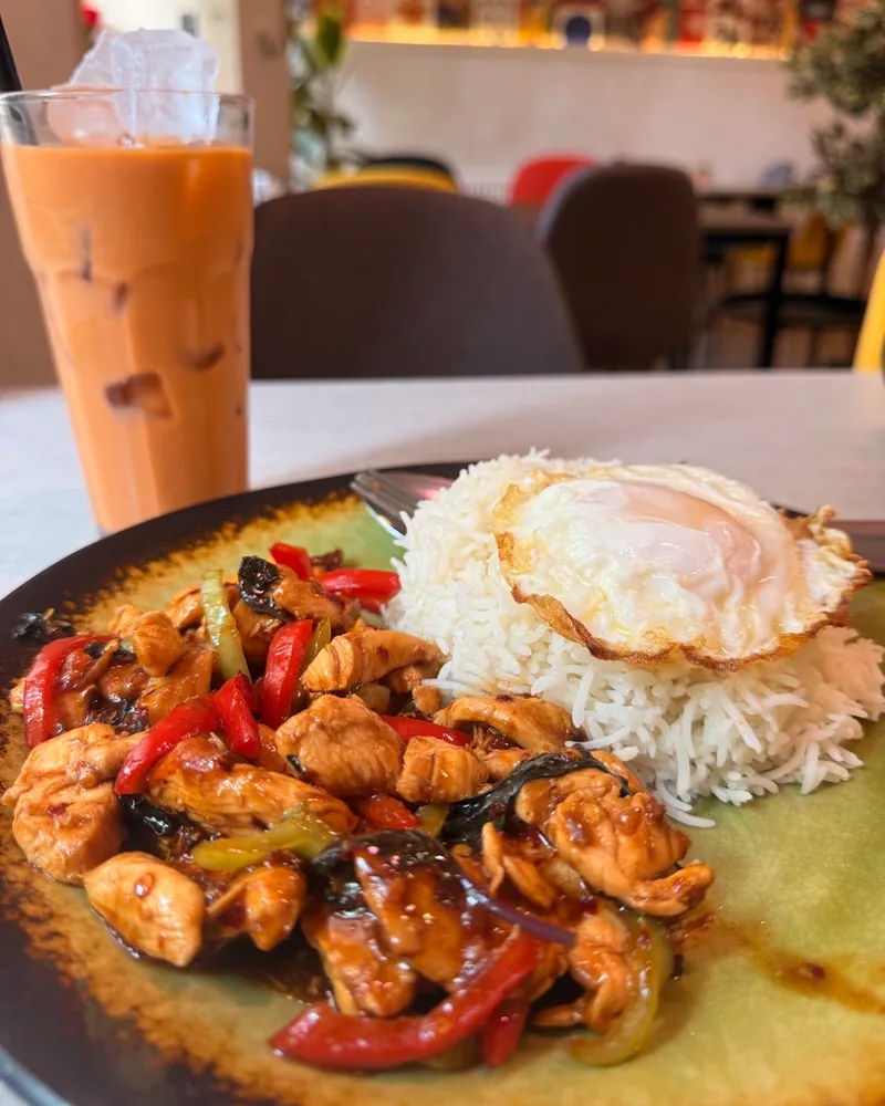 Stir-fried chicken with basil, rice and a fried egg at The Noodle House