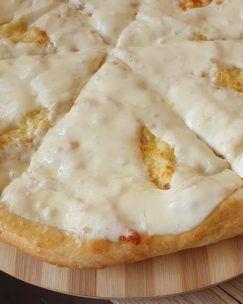 Ossetian khachapuri on a wooden board at The Osetian Khachapuri House