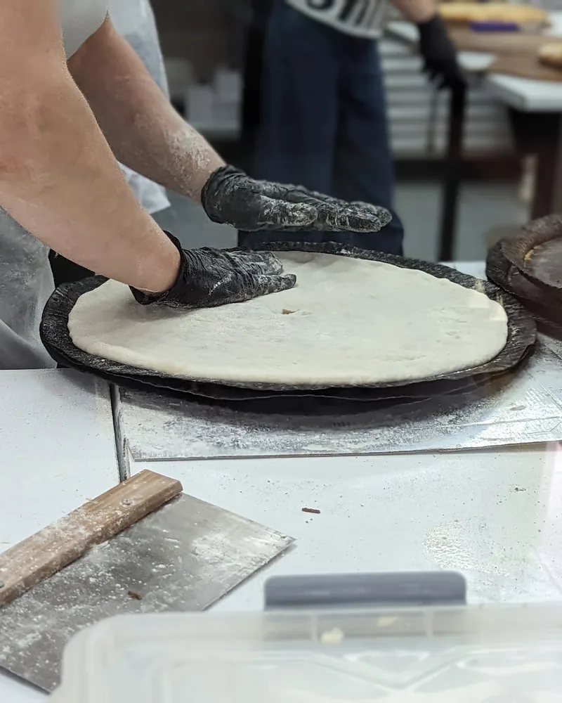 Khachapuri dough being prepared by hand at The Osetian Khachapuri House