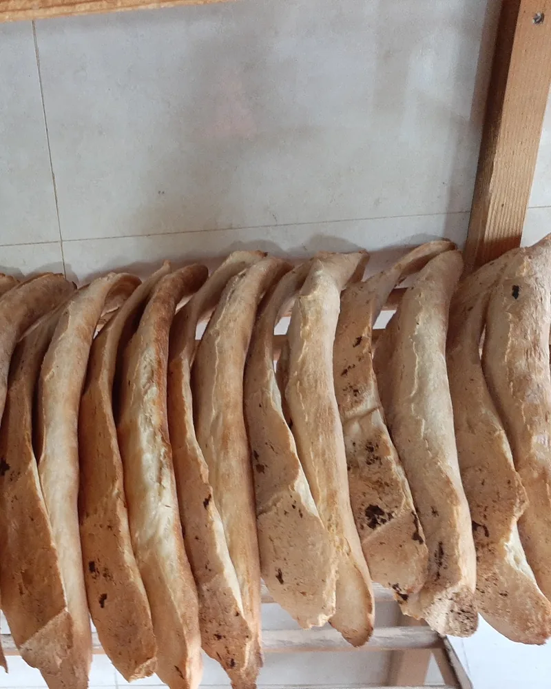 Freshly baked shoti bread on wooden racks at Tone (Georgian Bakery)
