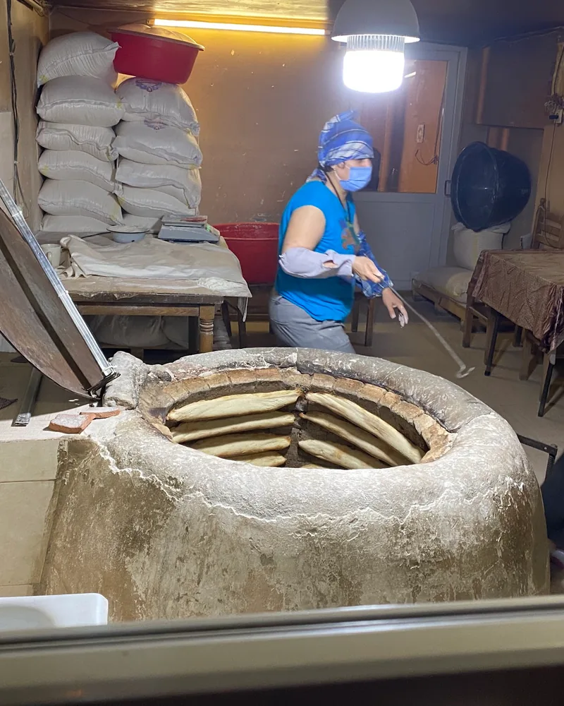 Traditional tone clay oven with baking bread at Tone (Georgian Bakery)