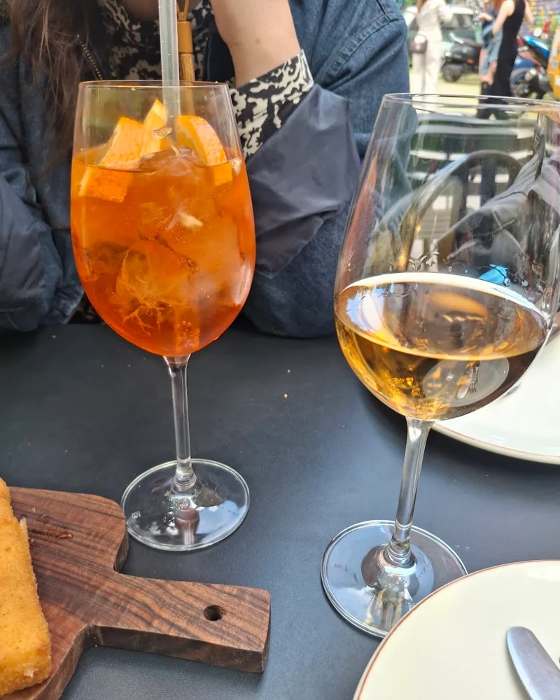 Spritz cocktail and a glass of white wine at Tone