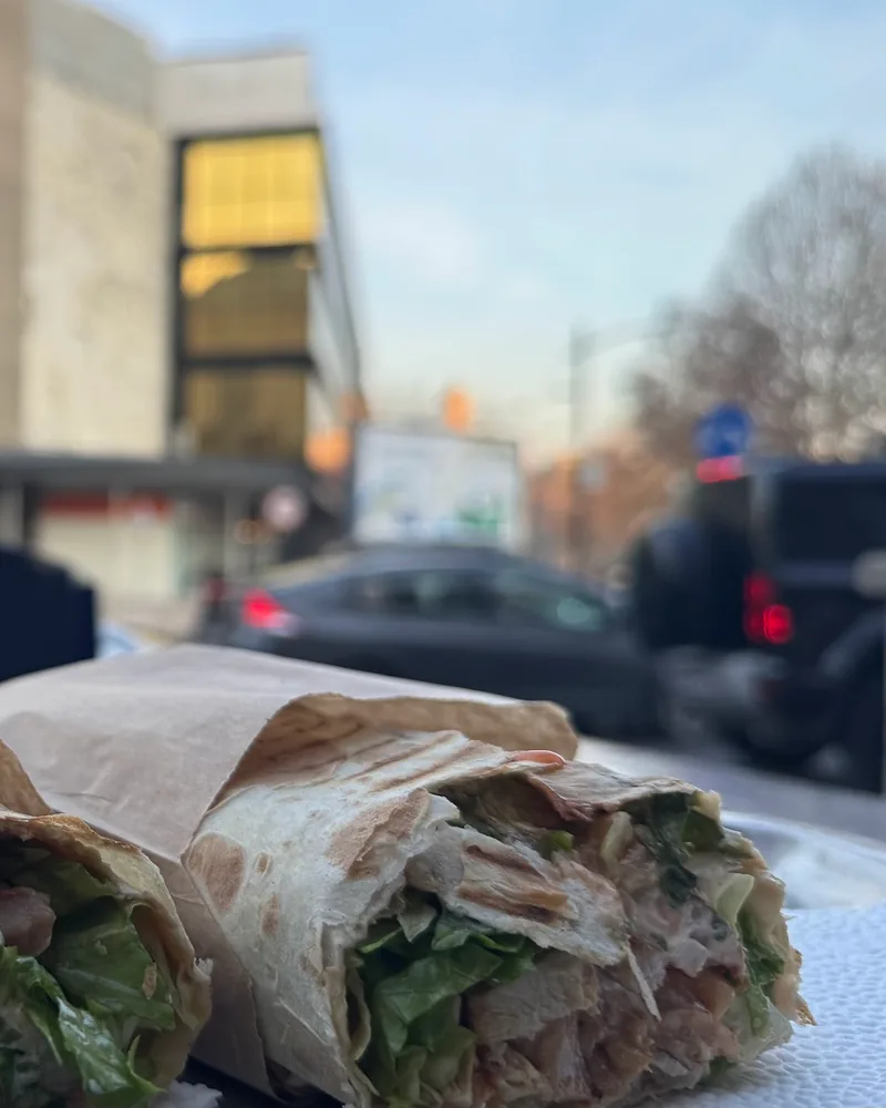 Two shawarma wraps wrapped in paper at Town