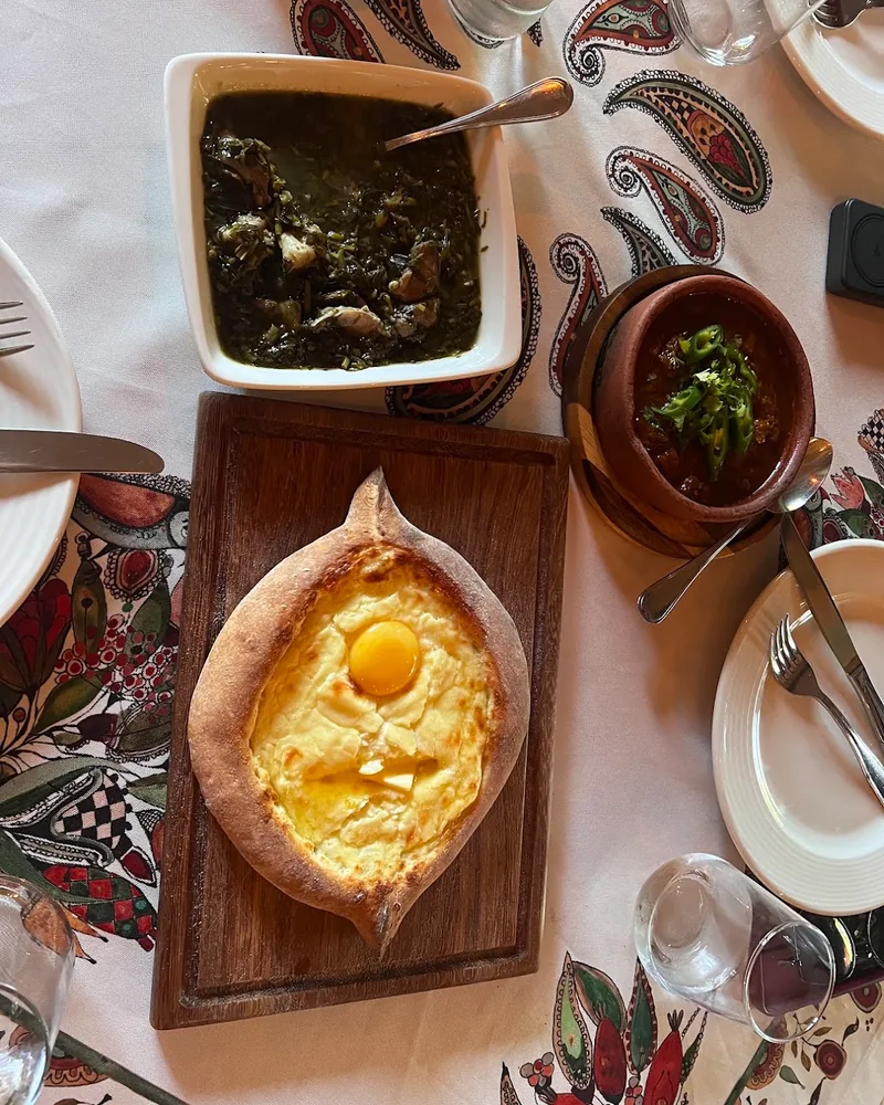 Adjarian khachapuri on a wooden board at Tsiskvili (Tskneti)