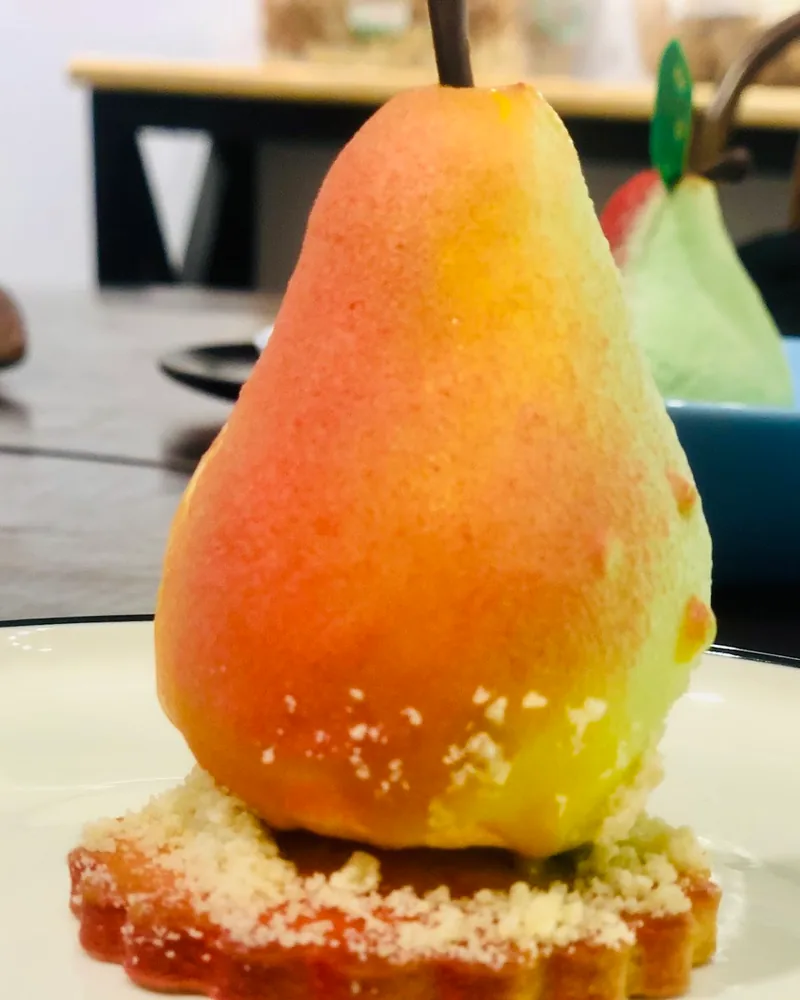 Pear-shaped pastry dessert on a biscuit base at Ars Gusto Culinary Academy