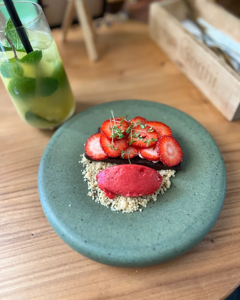 Chocolate dessert topped with sliced strawberries and sorbet at Van Goghi