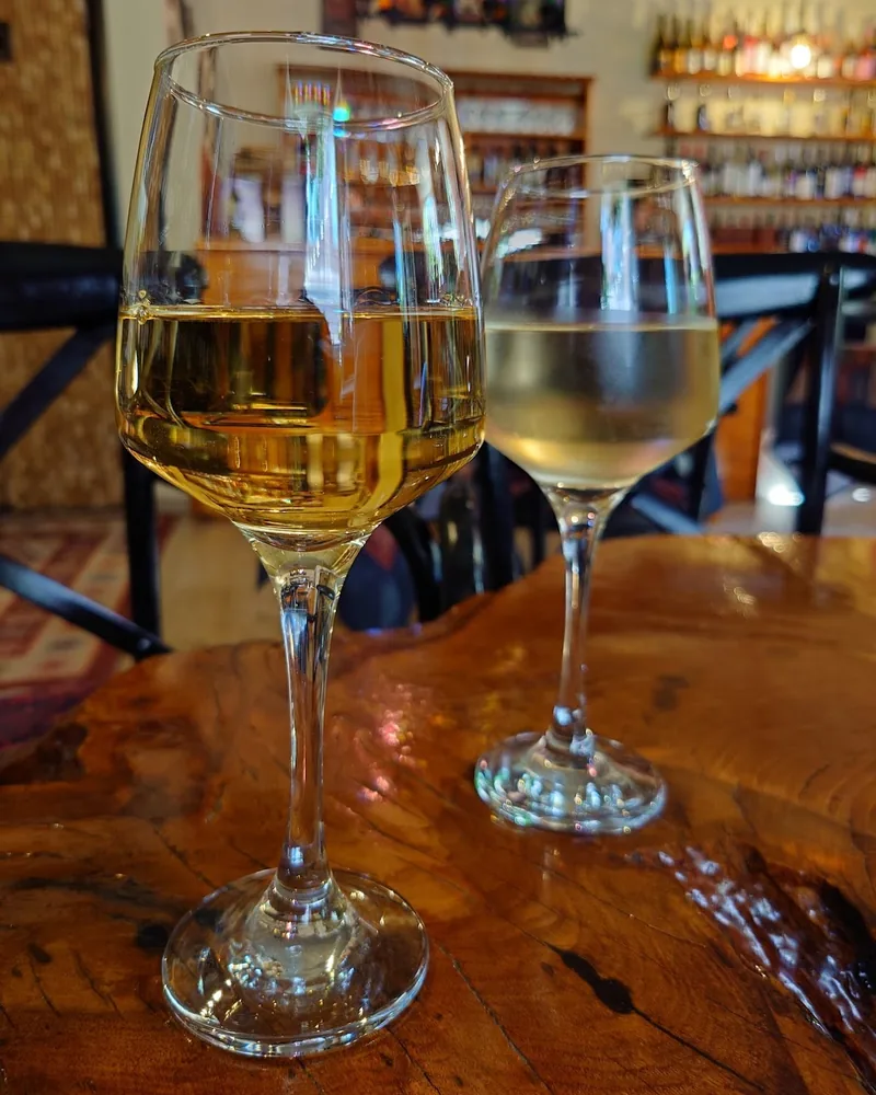 Glasses of white wine on a wooden table at Vinissimo
