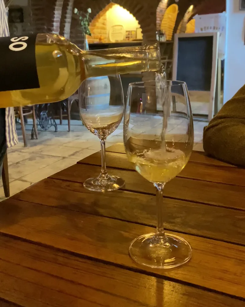 White wine poured into a stem glass at Vino Underground