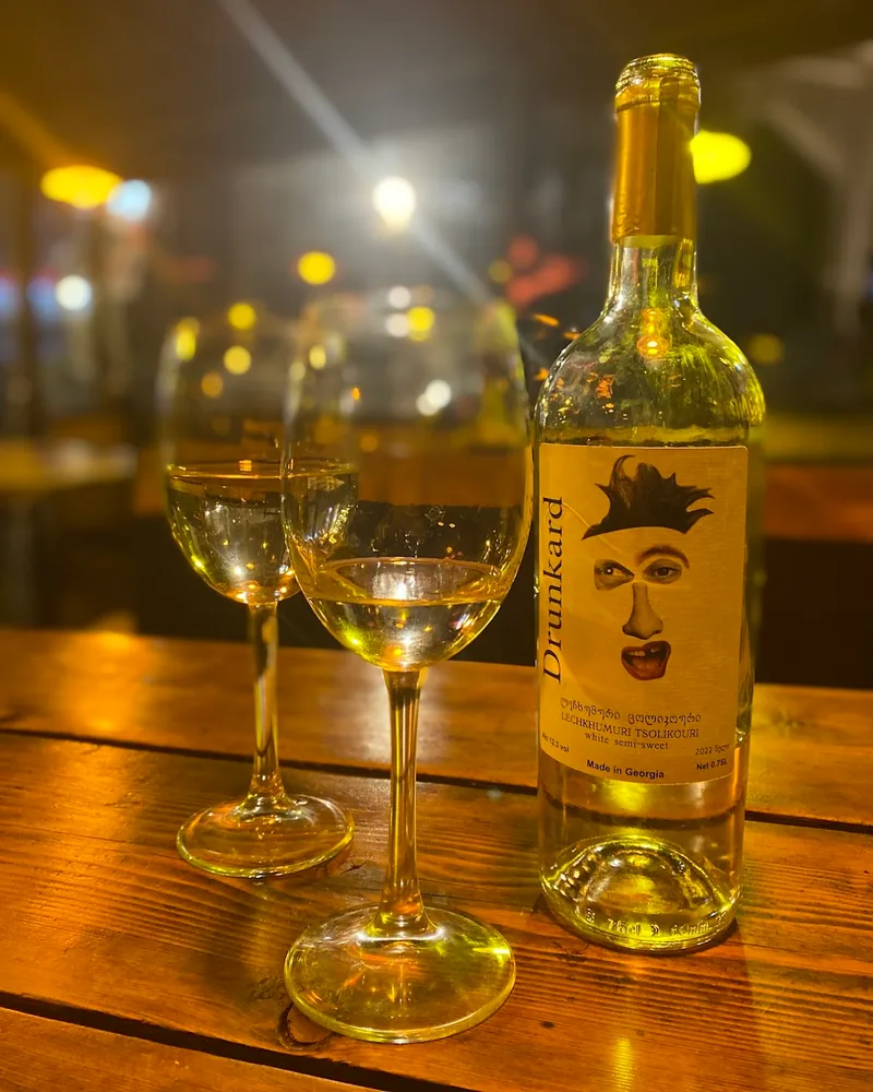 Bottle of Drunkard white wine and two filled wine glasses at Vinoground