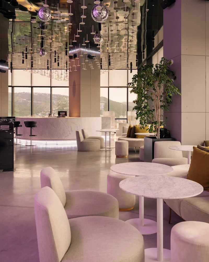 Modern lounge with disco balls and a mountain view at Weather Report Sky Bar