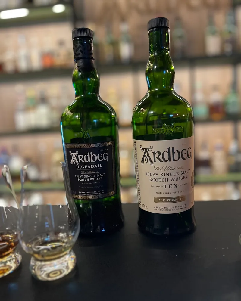 Bottles of ardbeg whisky with tasting glasses at Whisky Club Bar