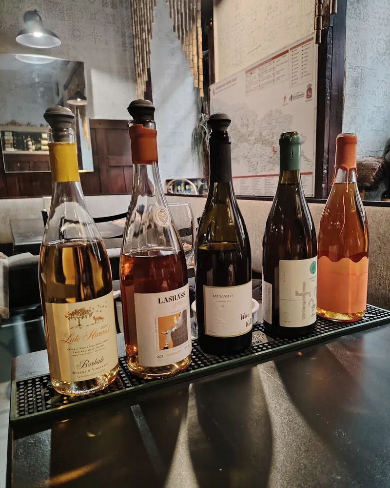 Wine bottles lined up on a bar mat at Sancho Wine Bar