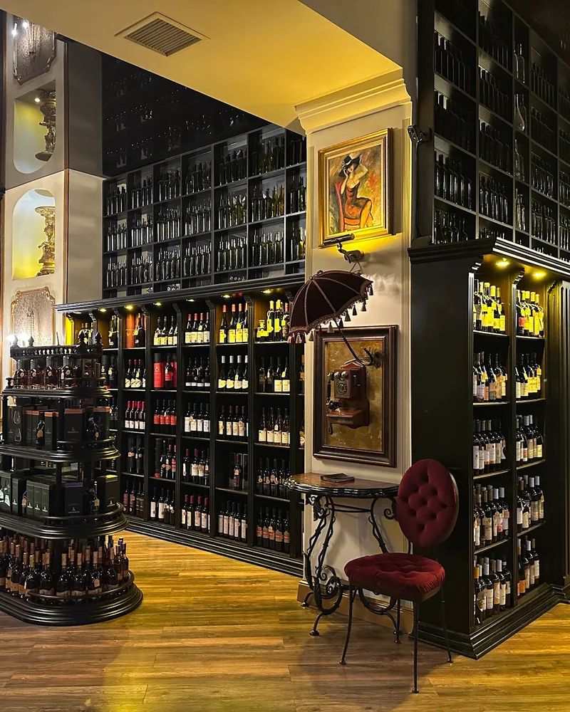Wine shop interior with towering bottle display shelves at Wine Gallery