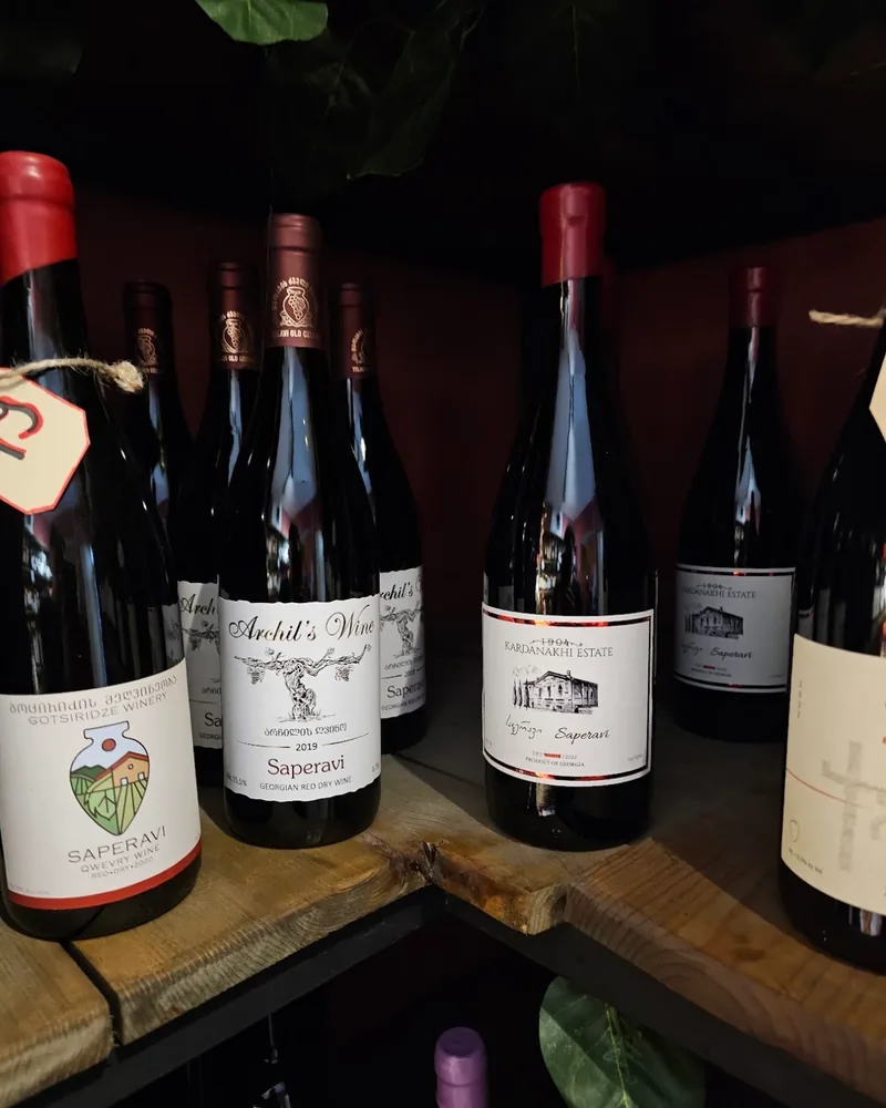 Saperavi wine bottles on wooden shelves at Wine Not?