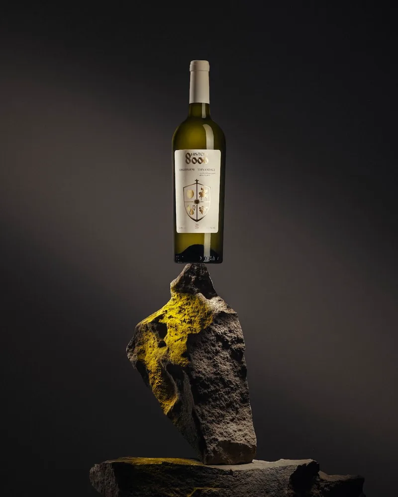 Bottle of white wine balanced on a rock at Meghvine