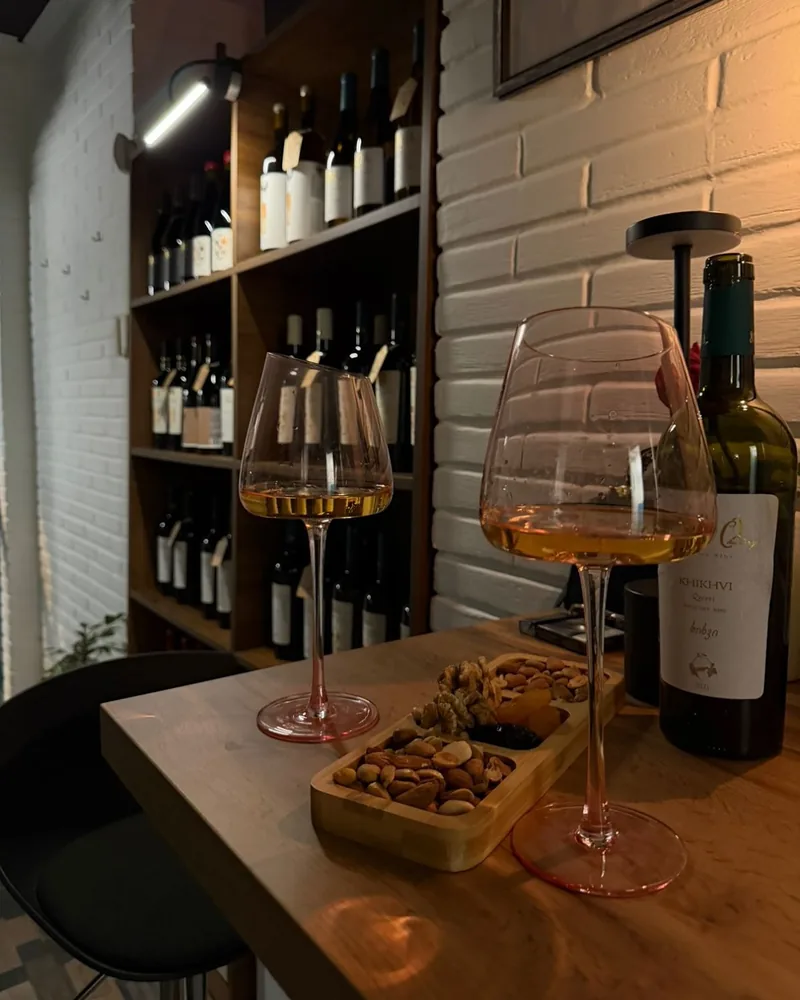 Amber wine in modern stemware with a snack tray at Meghvine