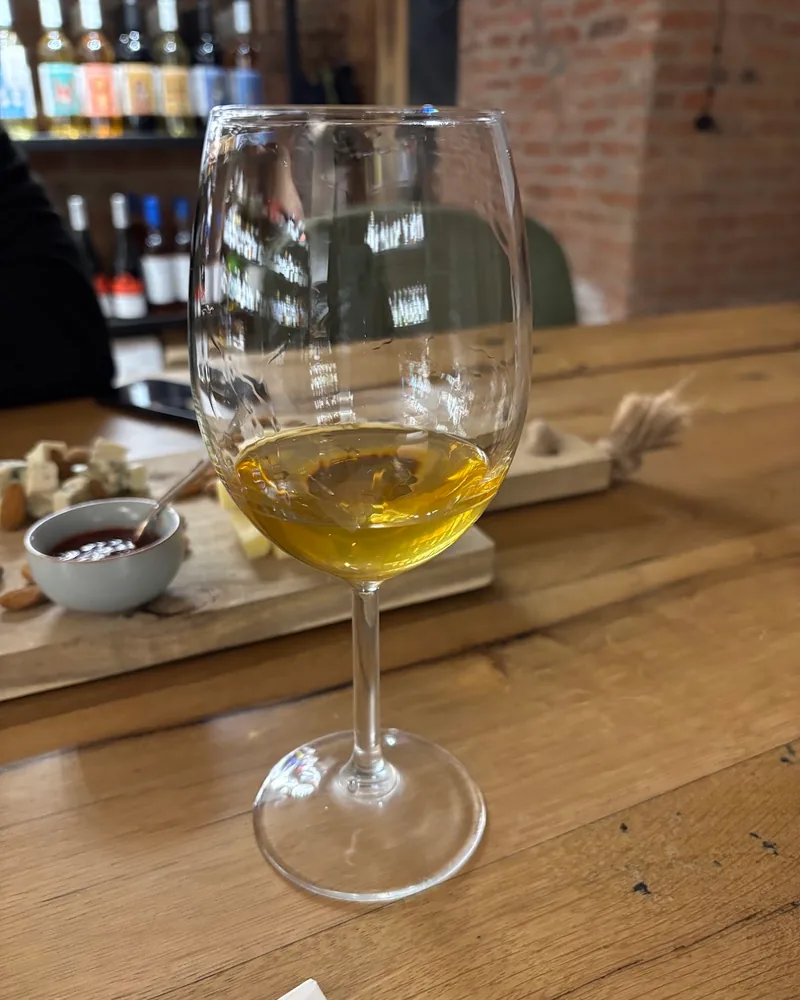 Amber wine in a wine glass at Wine Store Orbeliani