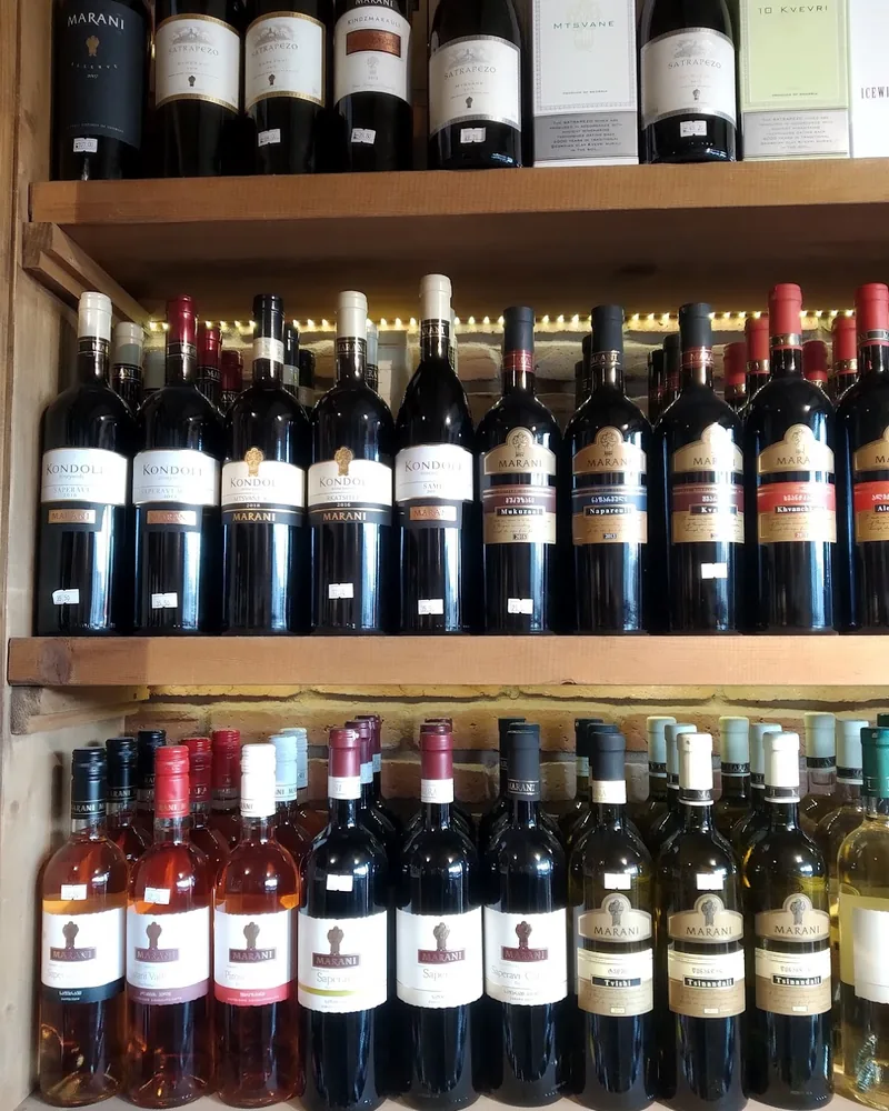 Wooden shelves lined with bottles of Georgian wine at Wine Time