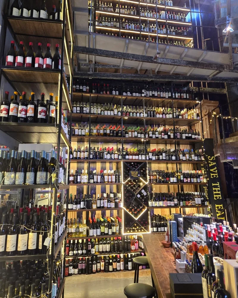 Wine bottle display wall and tasting counter at Wine Tower