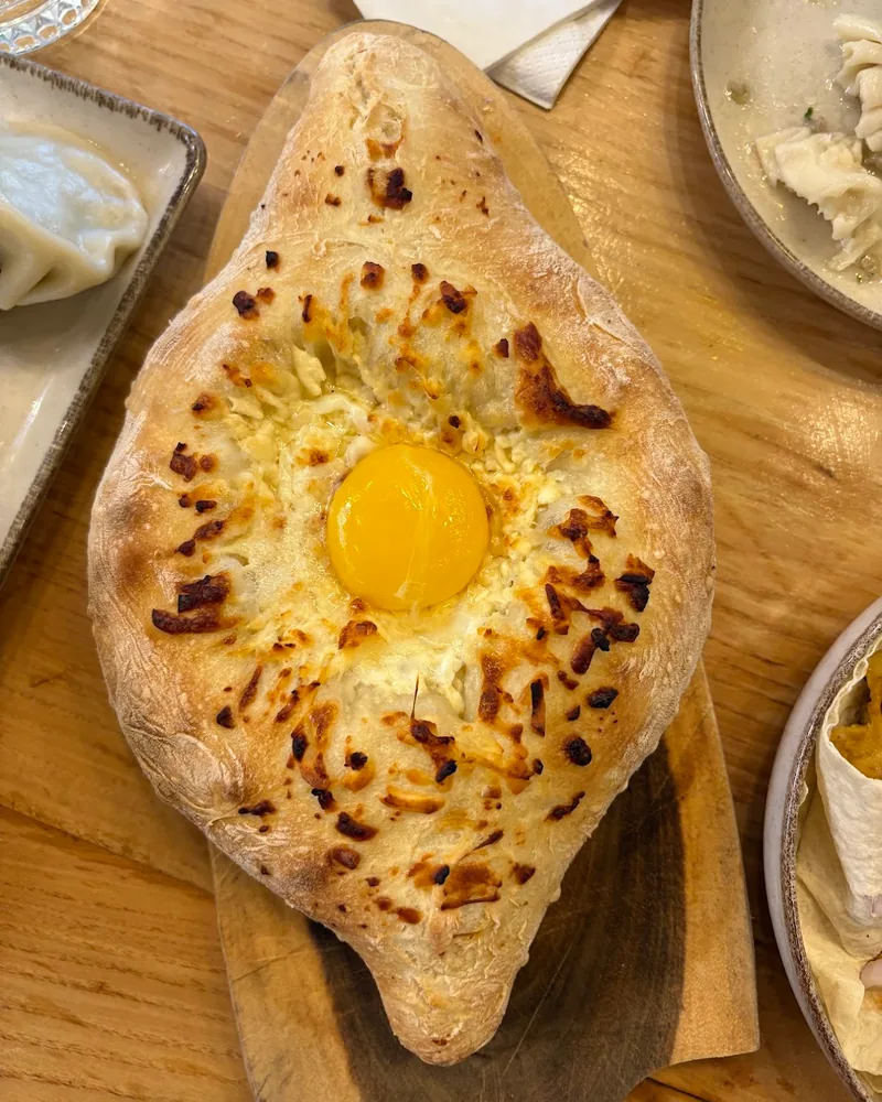 Adjarian khachapuri on a wooden board at WineCode