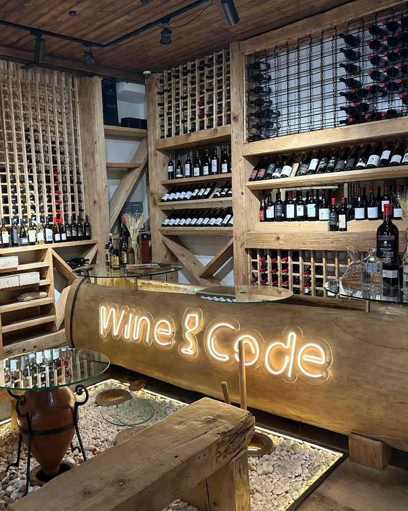 Tasting room with wine racks and glowing counter at WineCode