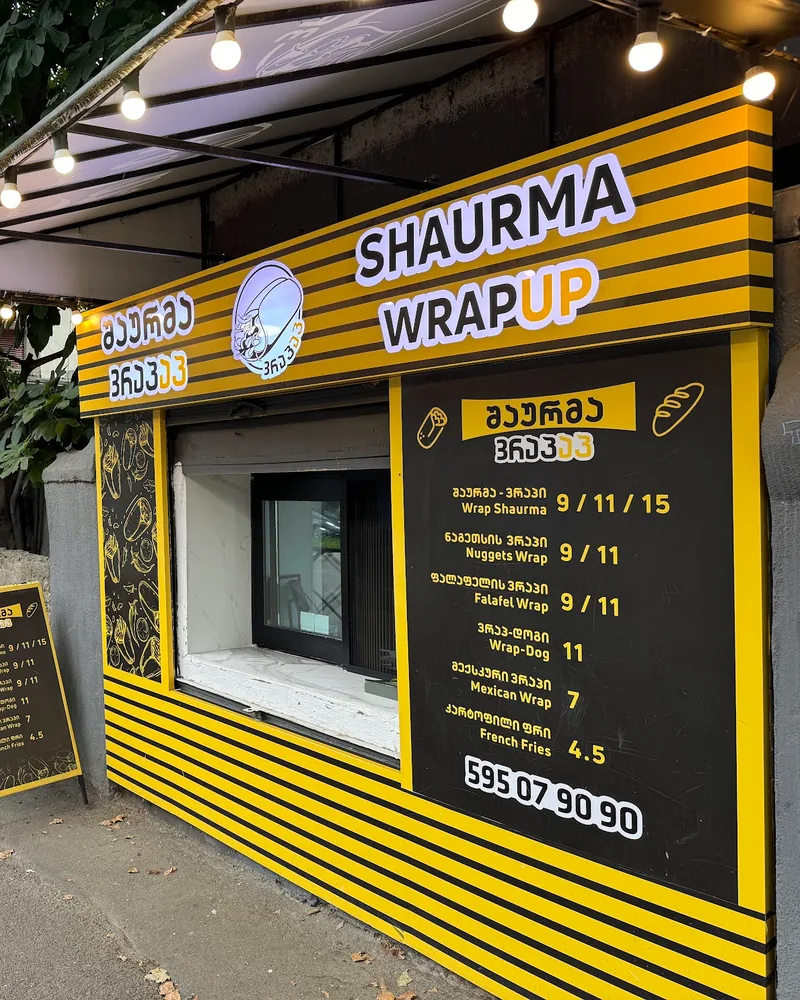 Takeaway kiosk facade with menu board at Wrap Up