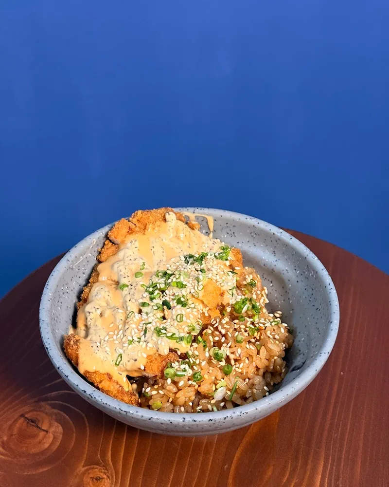 Katsu rice bowl with sauce and sesame seeds at Yuki Yume