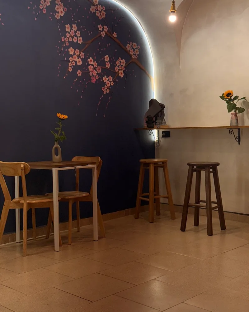 Seating area with cherry blossom mural and bar stools at Yuki Yume