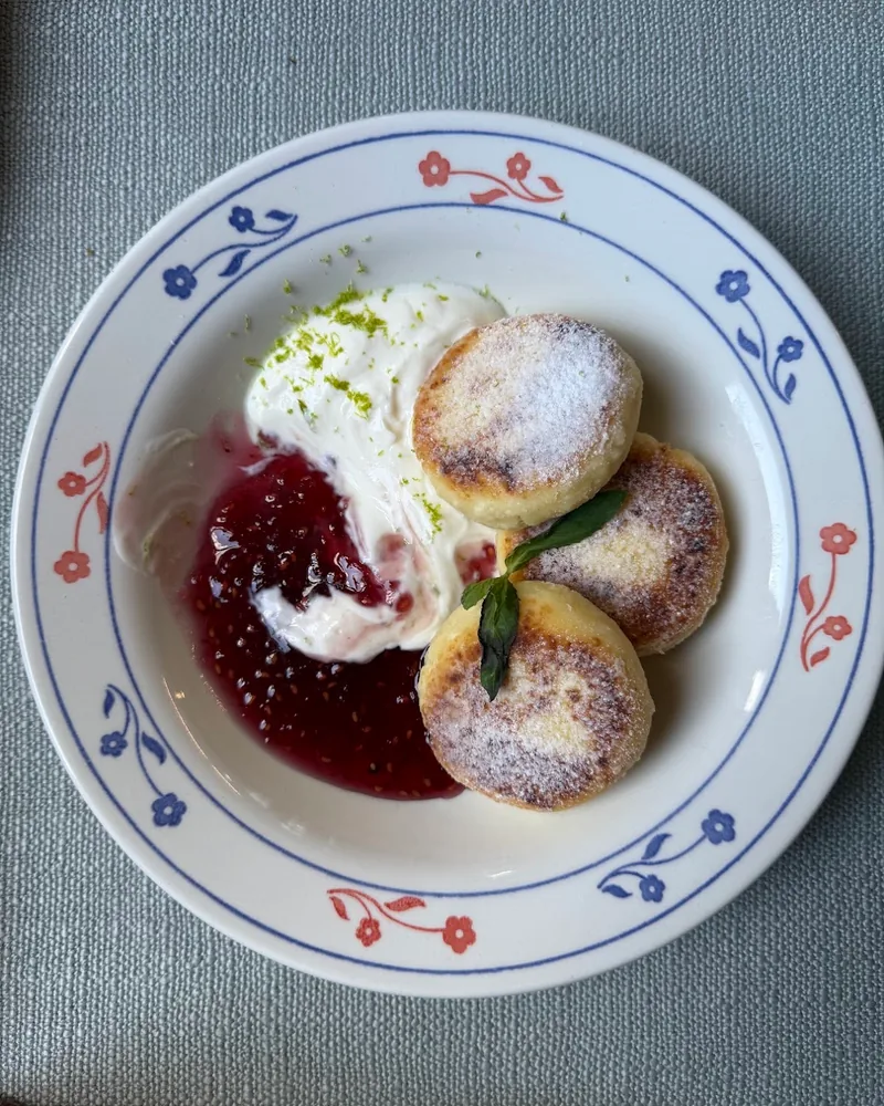 Syrniki with sour cream and berry jam at Zilina Cafe