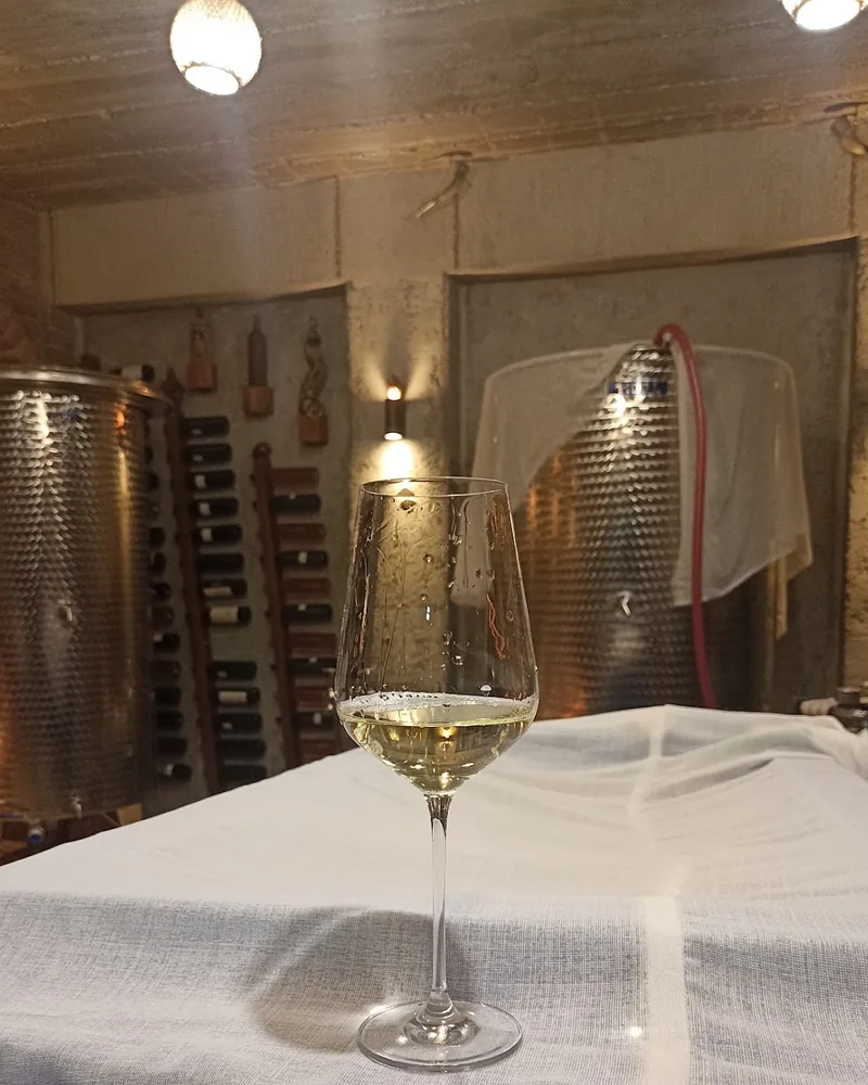 Glass of white wine on a linen-covered table at Zuzu's Winery